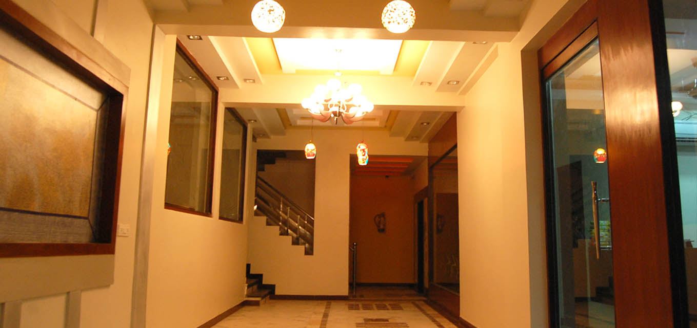 The lit ground-floor corridor leading to the stairs and lift.
