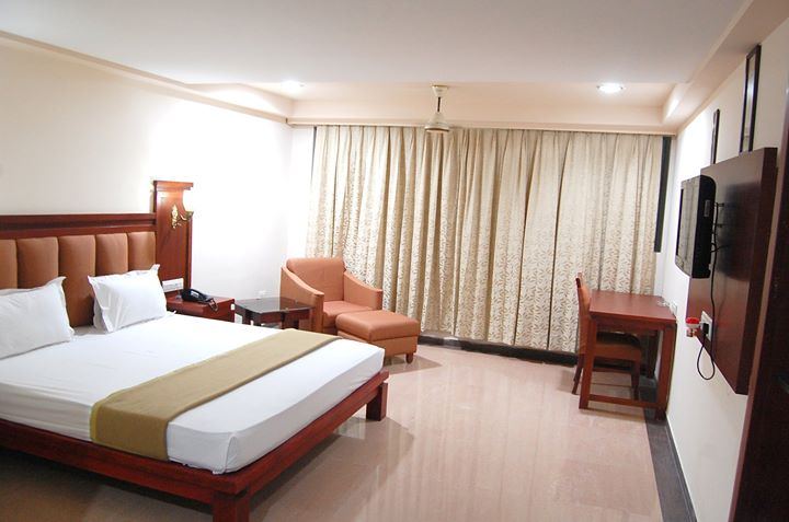 A Family Suite arranged with two beds and a lounge corner.