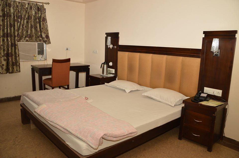 A Super Room with twin windows and carved wooden furniture.